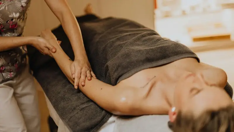 A Masseuse Massaging a Woman's Arm